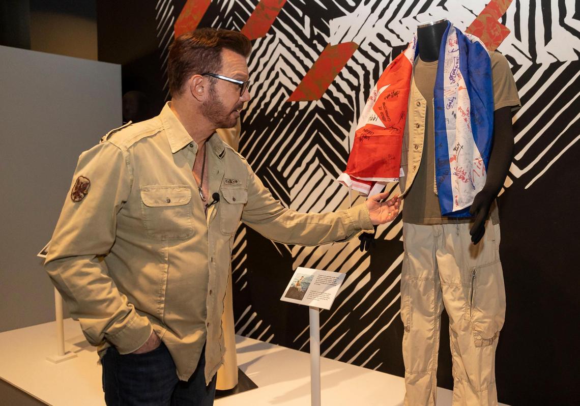 Willy Chirino tours ‘Willy Chirino: 50 Years of Music,’ on display at the HistoryMiami museum through Sept. 10. A flag signed by rafters at Guantánamo base is displayed next to the clothes Chirino wore to his concert in 1994.