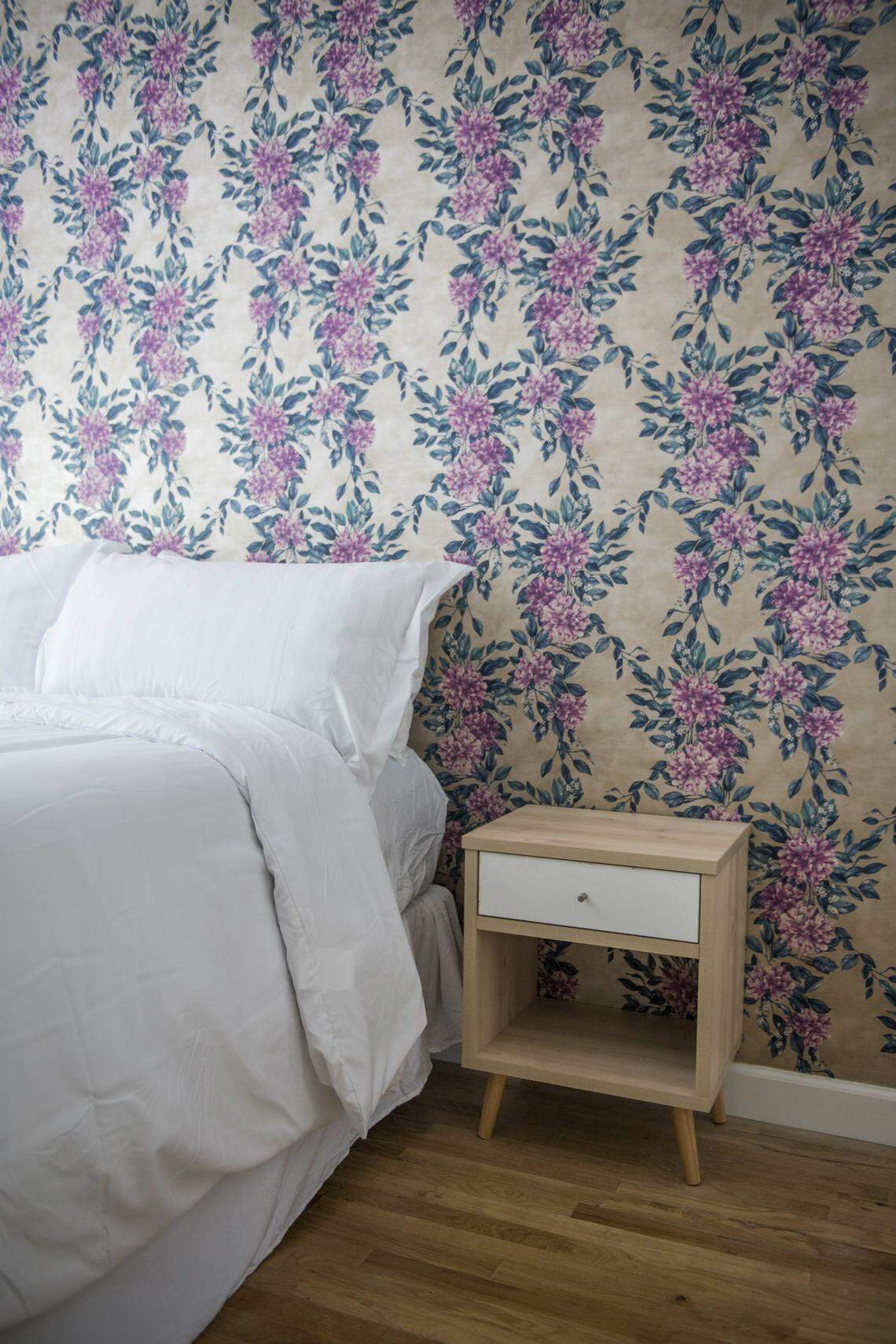 One guest room features&nbsp; complex floral-print wallpaper, while its neighbor’s walls sport crisp and clean geometric lines. Photograph by Felipe Cuevas.