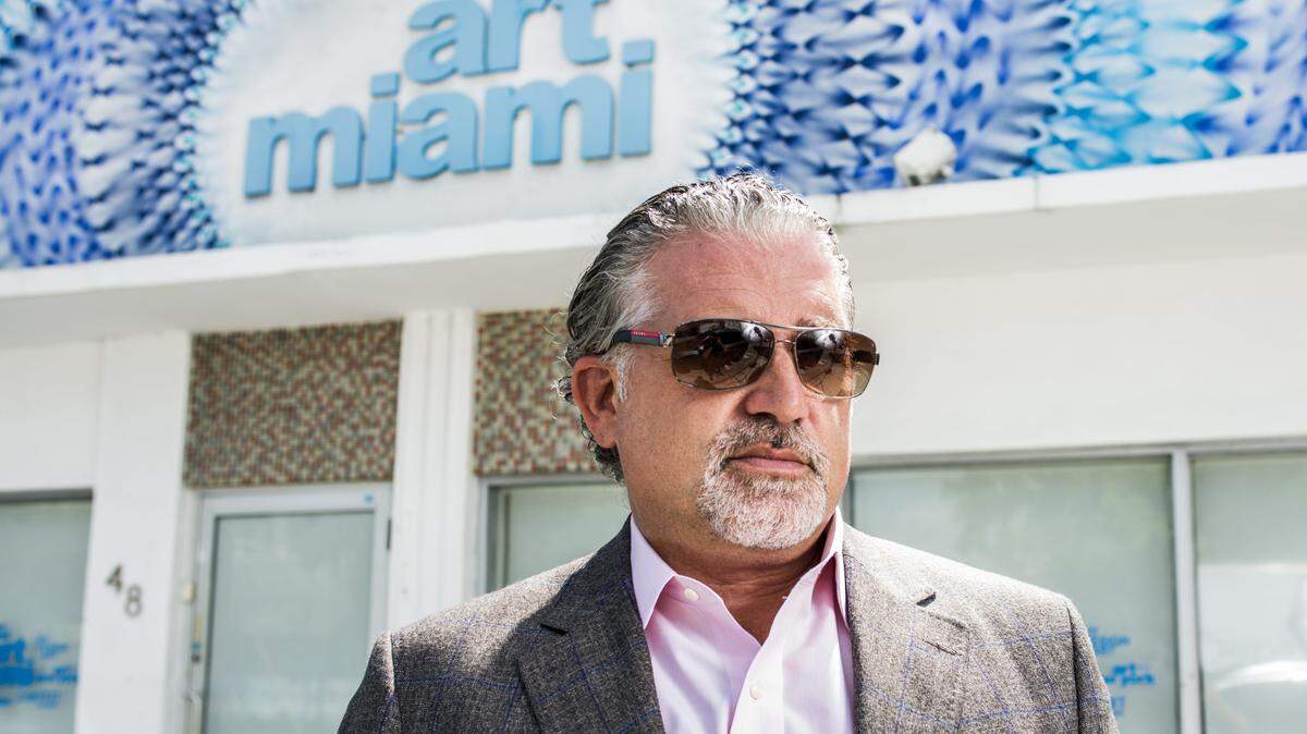 Nick Korniloff stands outside the Art Miami office in midtown. Photograph by Felipe Cuevas. Art Miami artwork by Douglas Hoekzema.