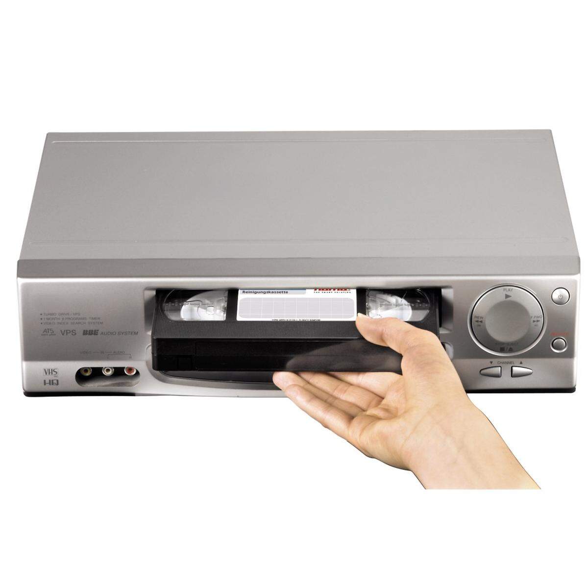 Image of a VHS tape in a player that converts the format to digital.