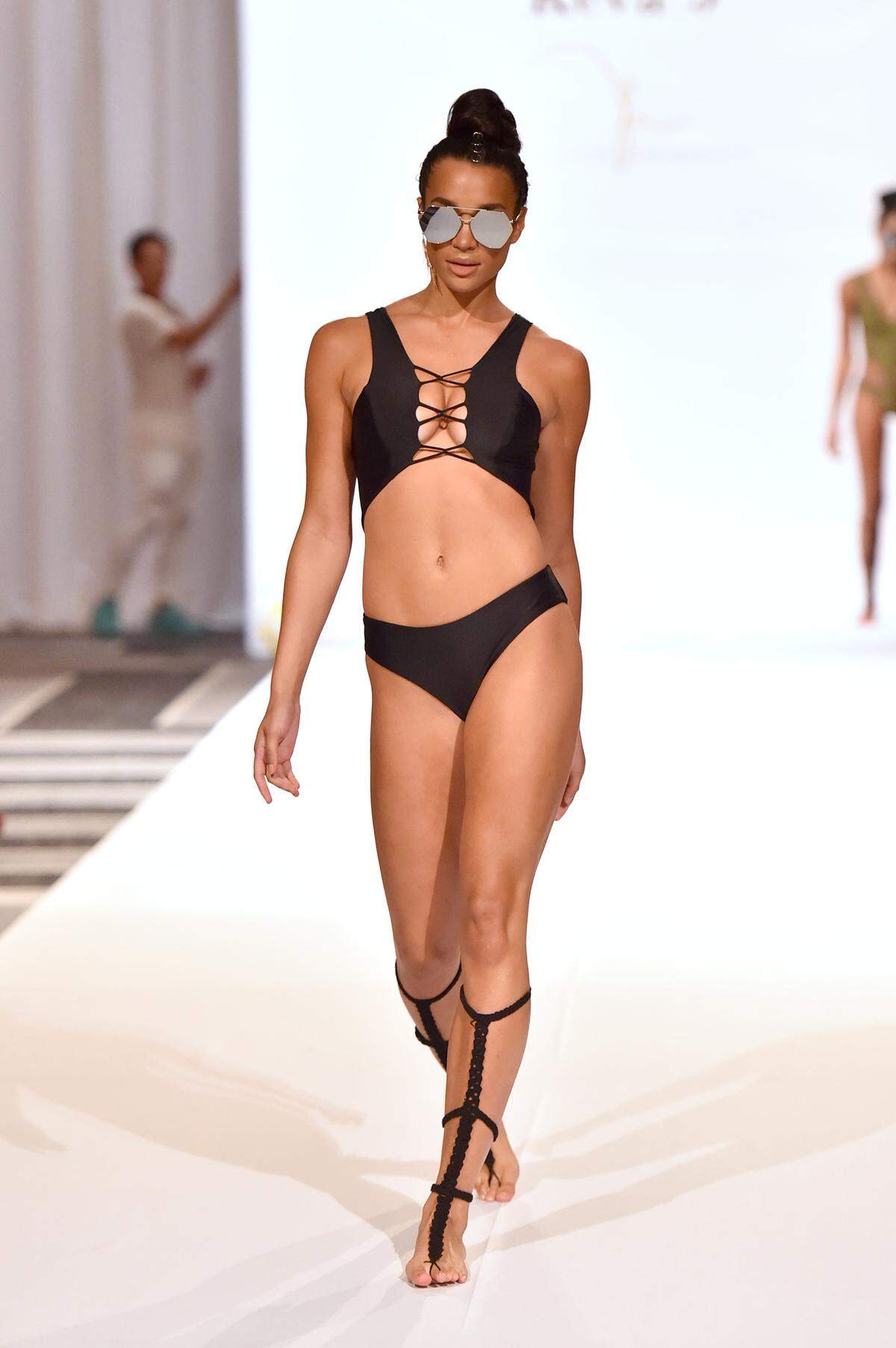 A model walks the runway during the Keva J Swimwear fashion show at Loews Miami Beach Hotel during Miami Swim Week. Photograph by Getty Images.