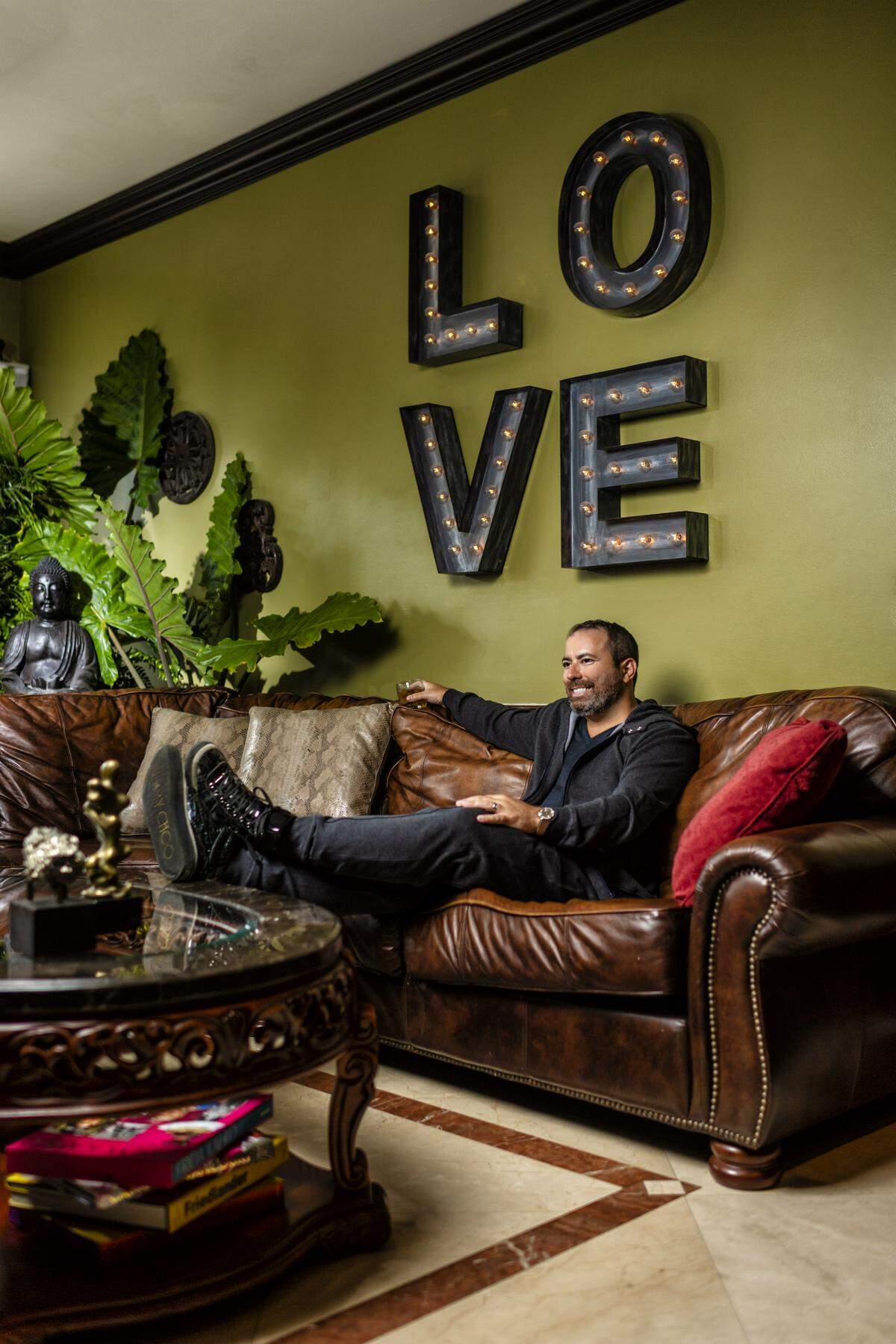 Manny Varas relaxes in his custom-built man cave in a cashmere hoodie, T-shirt and pants by Brunello Cucinelli from Saks Fifth Avenue at Brickell City Centre; sneakers by Jimmy Choo. Photograph by Nick Garcia. Styling by Elysze Held.