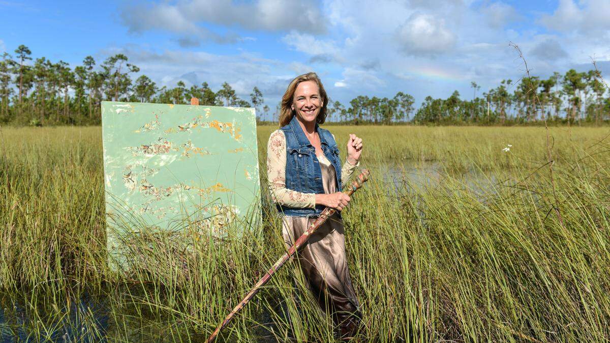 Deborah Mitchell stands in the Everglades, surrounded by art. Photograph by Christina Mendenhall.