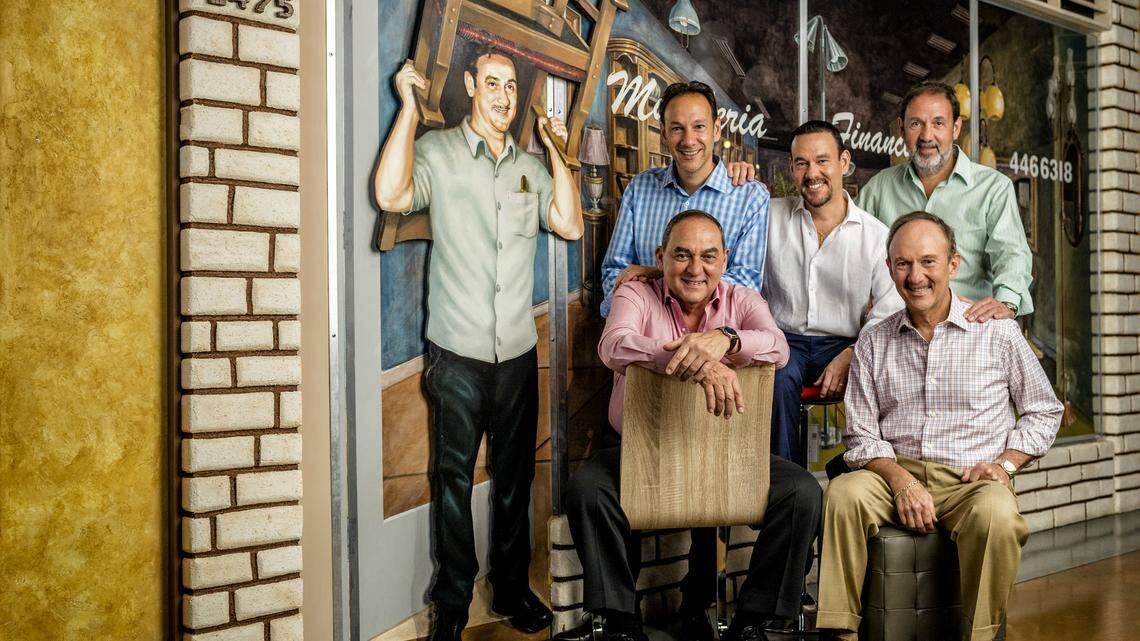 The Capó brothers of El Dorado Furniture in their original Calle Ocho showroom with a mural of their father, who founded the company in 1967. Photograph by Nick Garcia for INDULGE.