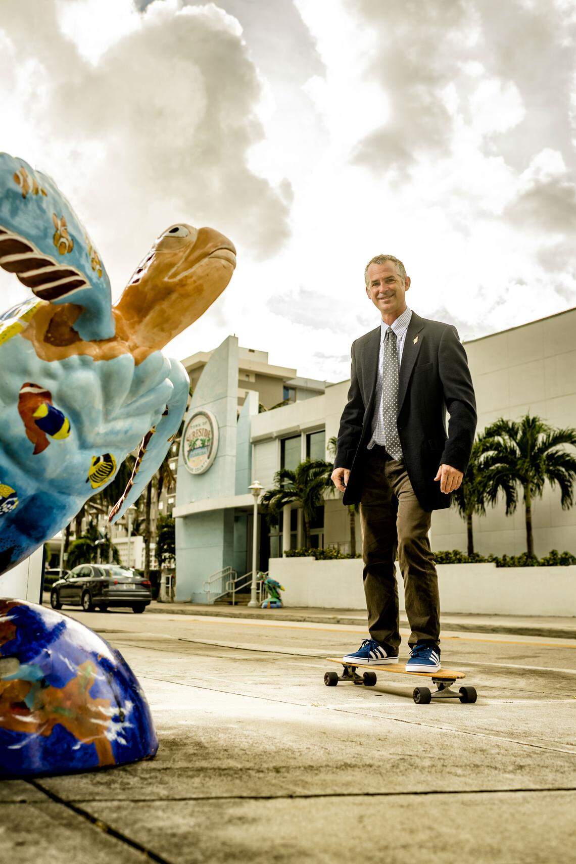 Mayor Daniel Dietch rides past public art in Surfside. Photograph by Nick Garcia.
