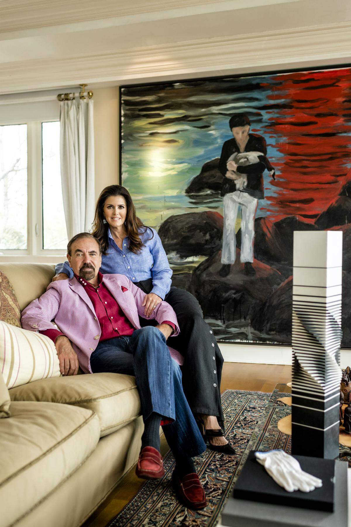 Jorge and Darlene Pérez at their Miami home. 'The Hunter' by Enrique Martinez-Celaya hangs in the background. The black-and-white sculpture in the foreground is a 1971 work by Spanish artist Francisco Sobrino, who died in 2014. Photograph by Nick Garcia.