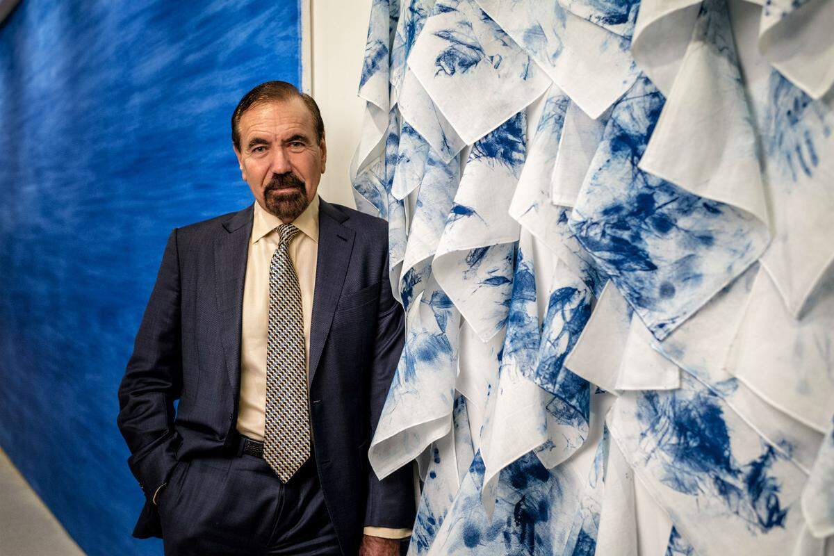 Jorge Pérez stands before a diptych in his office by Cuban artist Elizabet Cerviño called Limpiar El Cielo (To Clean the Sky). She created it by wiping blue paint from a canvas with 225 handkerchiefs. Photograph by Nick Garcia.