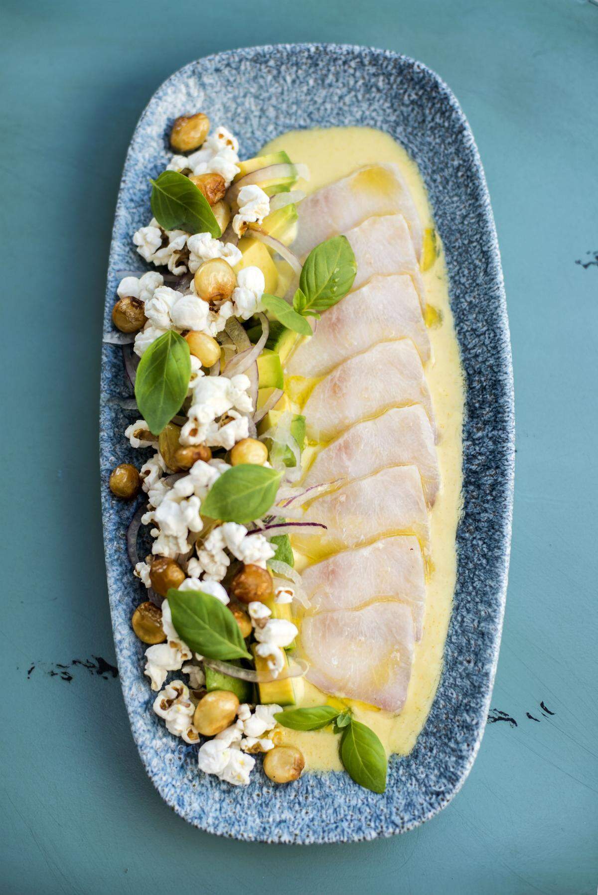 Cobia Tiradito at Stiltsville Fish Bar is served with crispy hominy, popcorn and avocado. Photograph by Felipe Cuevas.