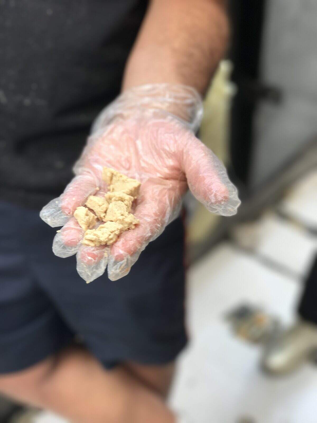 A vendor offers a sample of halvah at Machne Yehuda market in Jerusalem. Photograph by Evan S. Benn.