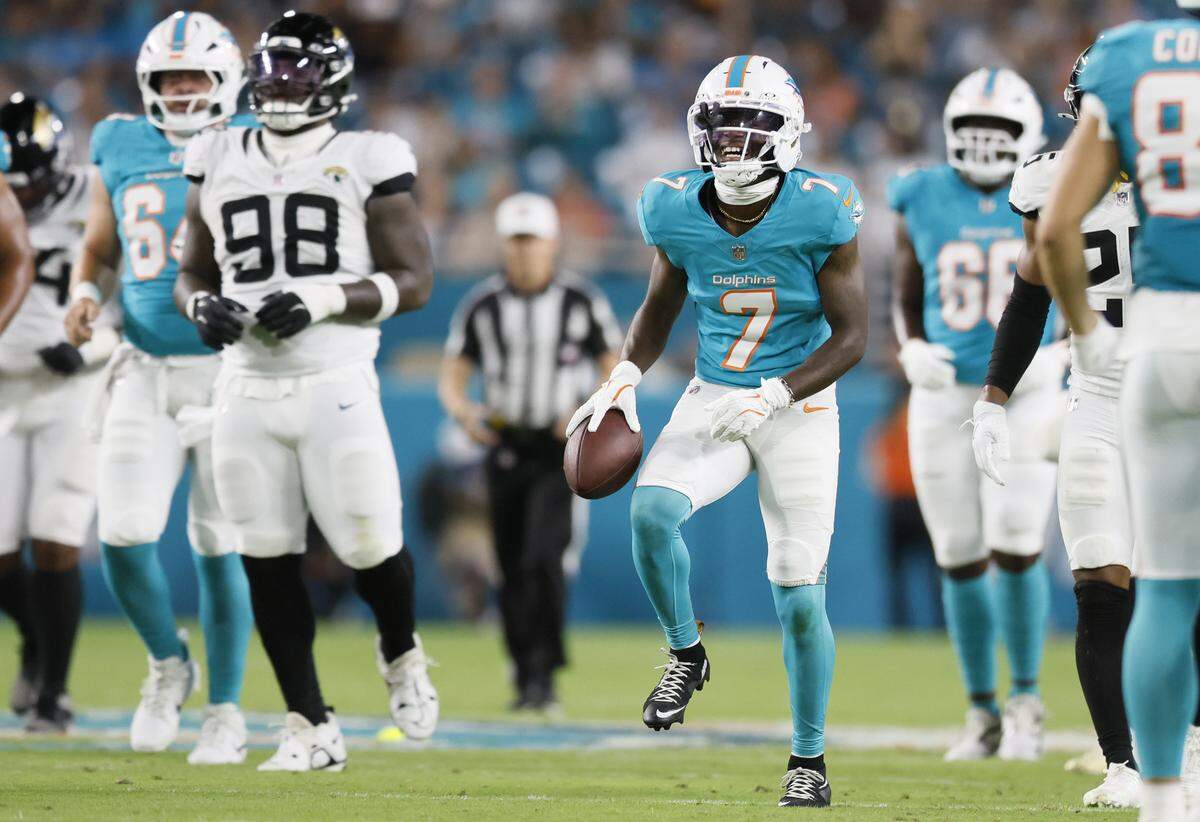 Miami Dolphins wide receiver Tahj Washington (7) reacts after a first down reception in the first half against the Jacksonville Jaguars during an NFL football game at Hard Rock Stadium in Miami Gardens, Florida, on Saturday, August 23, 2025.