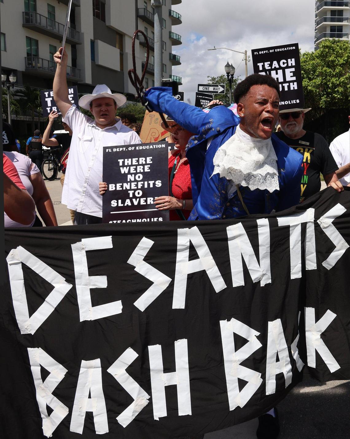 Jonathan Gartrelle, right, leads a group of roughly 80 protesters in chants as they marched toward the MDCPS administration building in protest of the new African American history standards approved by the state, Wednesday, Aug. 16, 2023 in Miami, Florida.