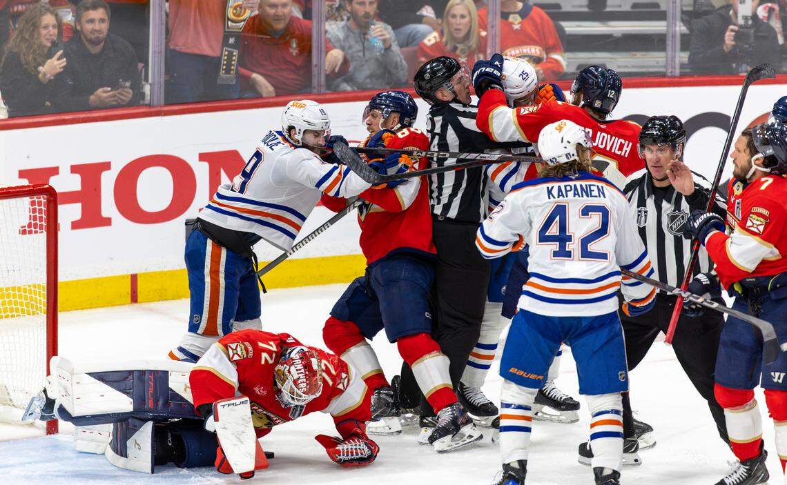 Florida Panthers goaltender Sergei Bobrovsky (72) lies on the ice as NHL linesmen Scott Cherrey (50) and Trent Knorr (74) attempt to break up multiple fights involving Edmonton Oilers center Adam Henrique (19), Panthers defenseman Nate Schmidt (88), Panthers left wing Jonah Gadjovich (12), Oilers defenseman Darnell Nurse (25), Panthers defenseman Dmitry Kulikov (7), and Oilers right wing Kasperi Kapanen (42) during the second period of Game 3 in the NHL Stanley Cup Final at Amerant Bank Arena on Monday, June 9, 2025, in Sunrise, Fla.