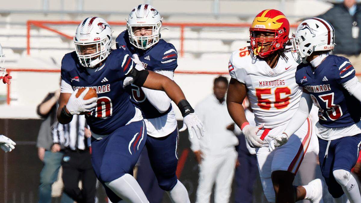 Chaminade-Madonna Lions defensive tackle Donta Simpson Jr. (90) picks up a fumble as Clearwater Central Catholic Marauders tackle Ray Lane (56) gives chase in the second half during the Class 1M, Region 3, District 6, State Championship game at Bragg Memorial Stadium in Tallahassee, Florida, on Thursday, December 7, 2023.