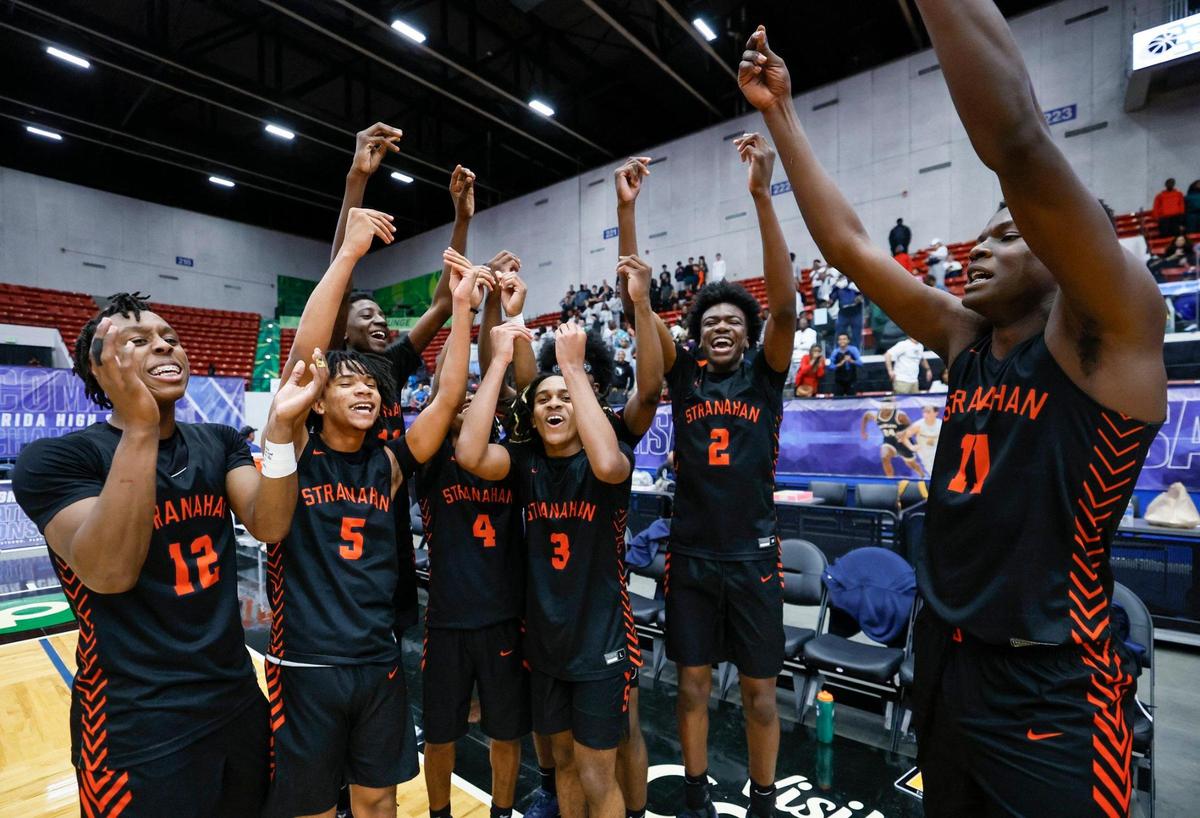 Stranahan High School’s Isaiah Brown (11), at right, celebrates with teammates after the win over Gibbs High Schoo for the FHSAA Class 4A Boys High School Basketball State Championship.at the RP Funding Center in Lakeland, Florida on Thursday, March 6, 2025. Brown scored to take lead and win in the final seconds of the game.