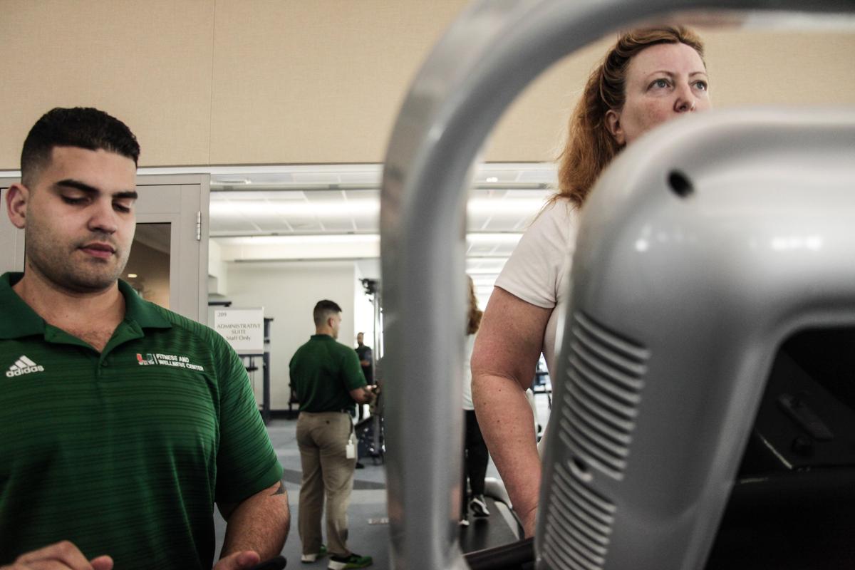 Michael Bello, a UHealth health and fitness specialist, works with his patient, Dr. Elizabeth Crucco, on a weight-loss program created for Crucco.