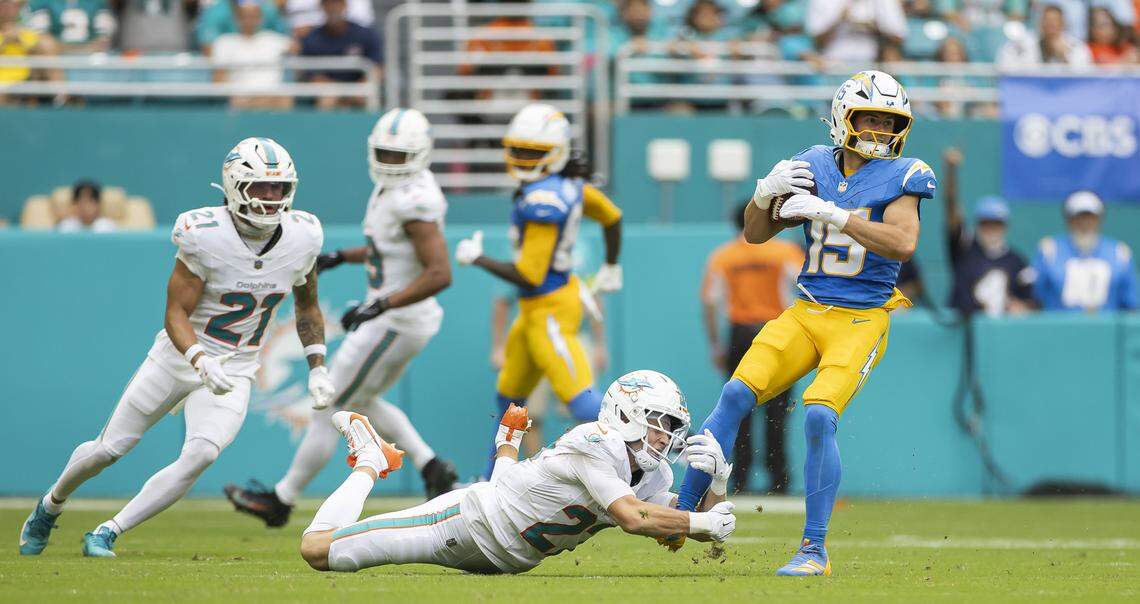 Miami Dolphins cornerback Ethan Bonner (27) fails to stop Los Angeles Chargers wide receiver Ladd McConkey (15) in the first half of their NFL game at Hard Rock Stadium on Sunday, Oct. 12, 2025, in Miami Gardens, Fla.
