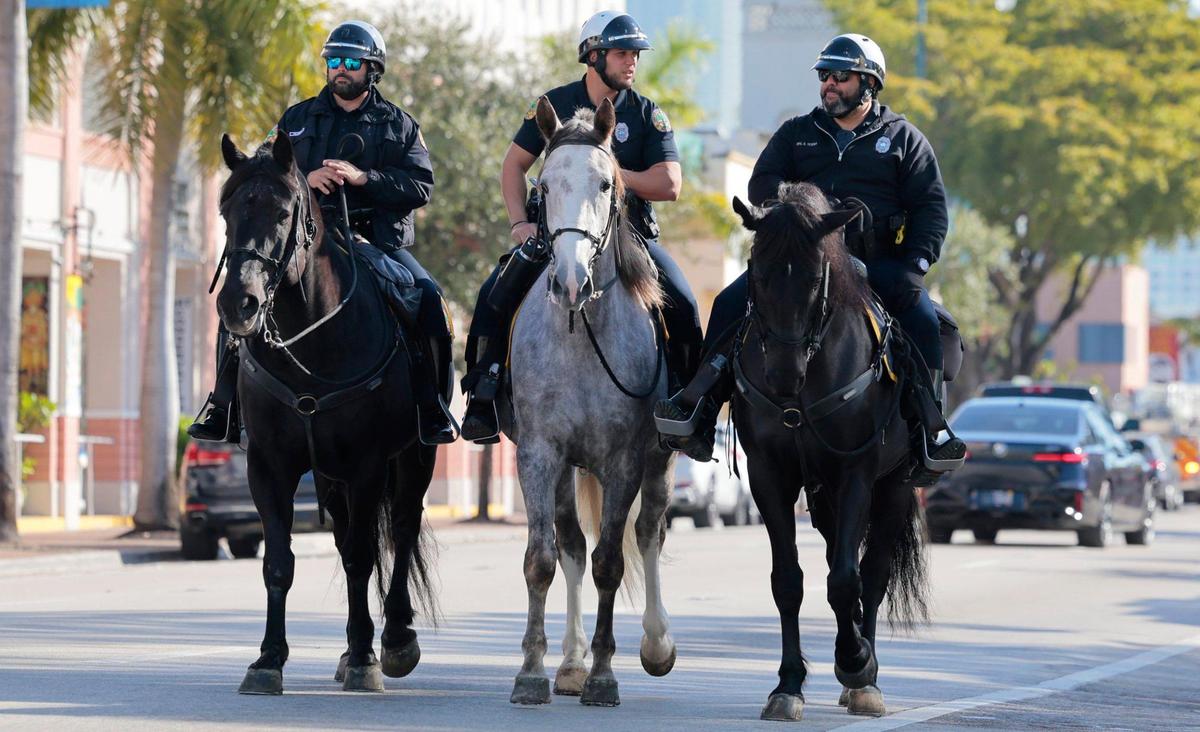 City of Miami mounted patrol officers, Palomino, Hernandez, and Tejeda ride their horses along Calle Ocho in Little Havana as the coldest air of the season arrives in South Florida on Wednesday morning, Jan, 8, 2025.