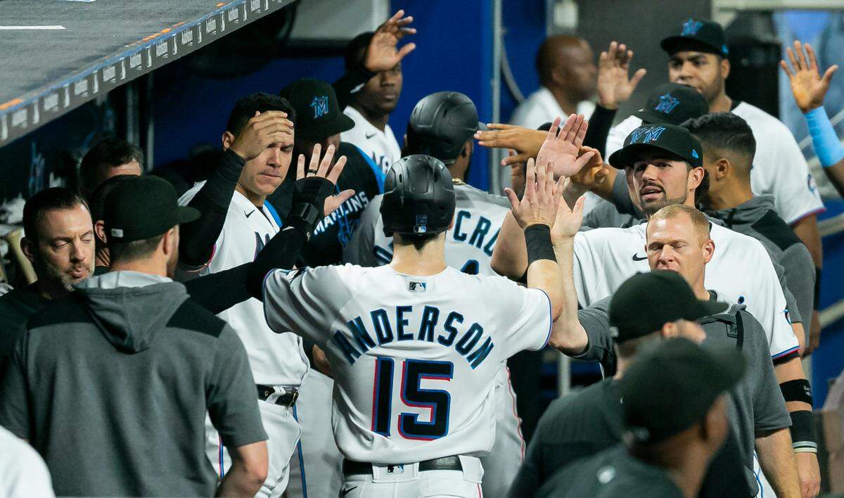 Miami Marlins third baseman Brian Anderson (15) celebrates after scoring a run against the Washington Nationals during the second inning of their baseball game at LoanDepot Park on Monday, May 16, 2022, in Miami, Florida.