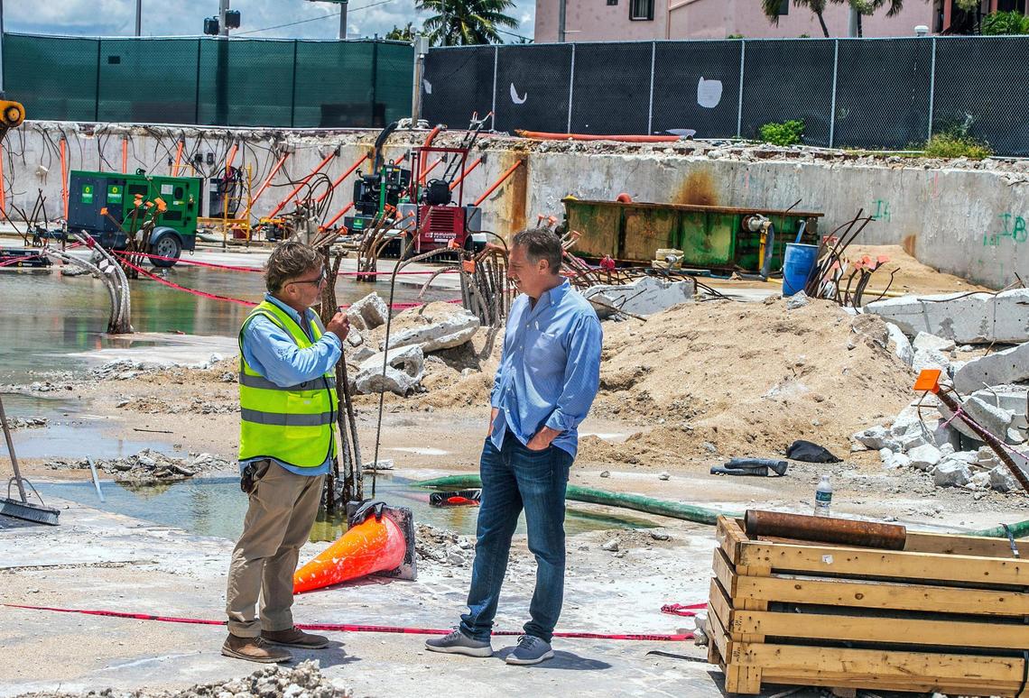 Attorney Michael I. Goldberg, right, a South Florida lawyer playing a pivotal role in the Champlain Towers South lawsuits, talks with building manager Scott Stewart in the parking deck, all that remains of the collapsed Surfside condo.