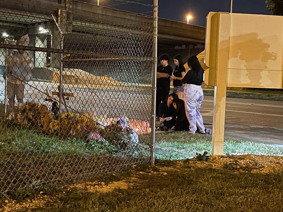 Friends of Anthony Gago and Jazmin Keltz mourn their loss at a vigil created by the site of the crash that killed them.