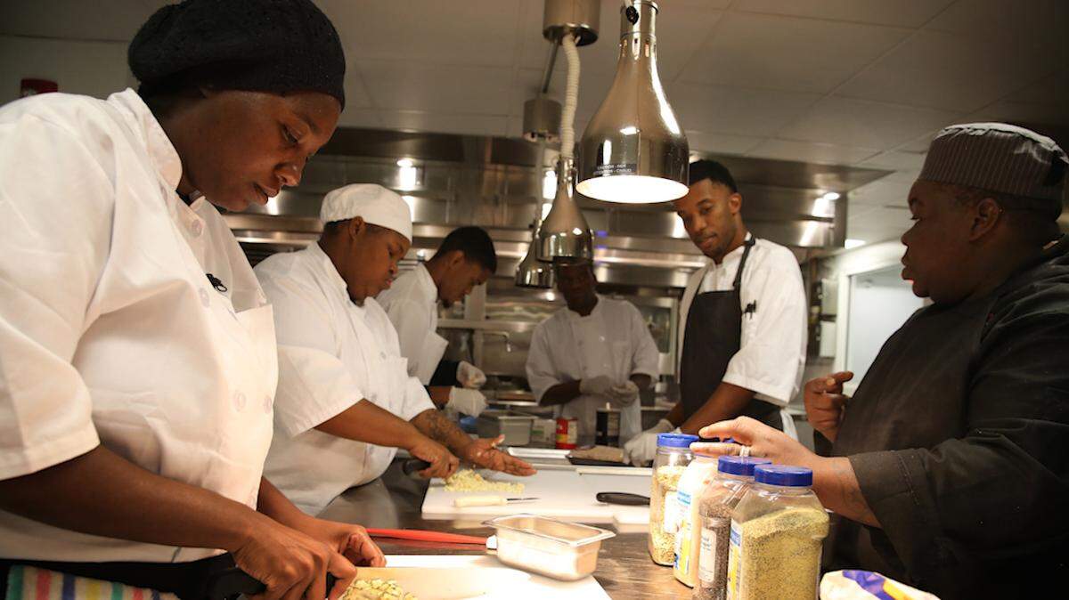 The Democratic primary debates in Miami will take place next door to Overtown, a low-income neighborhood where residents need job training, like this culinary program.