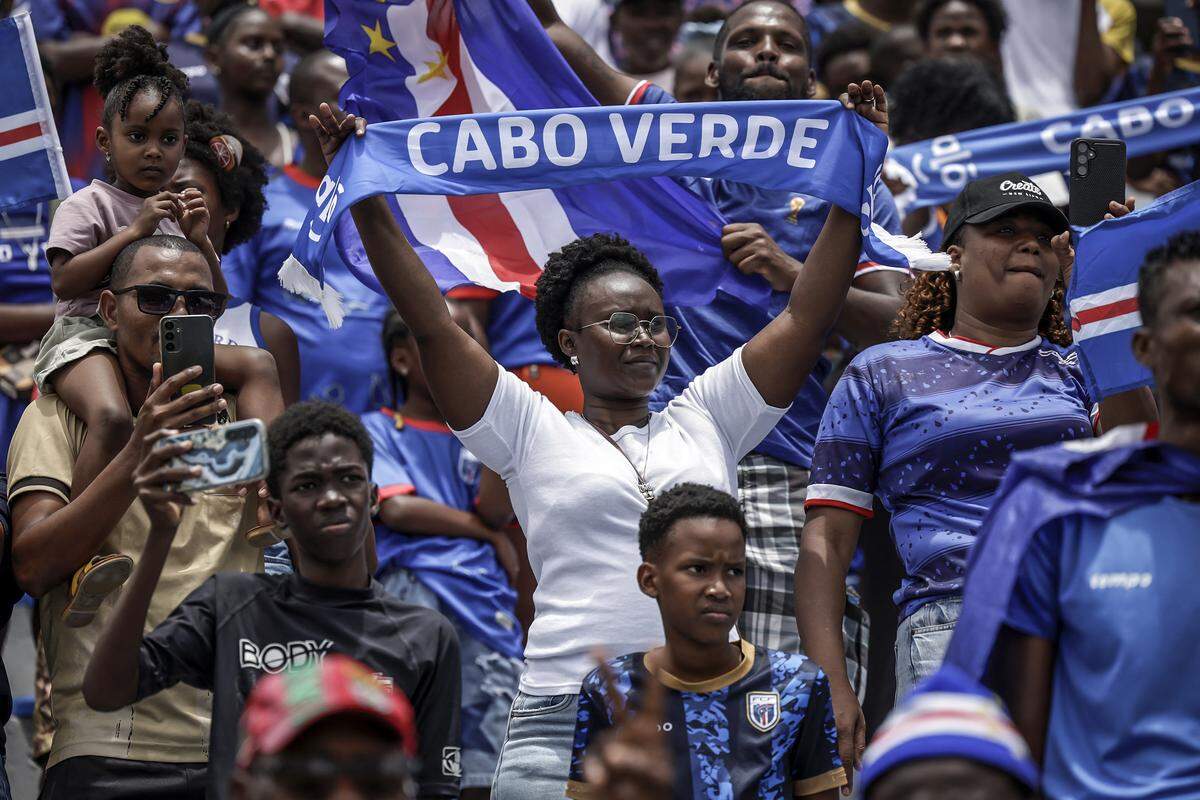 Cape Verde fans wave flags and scarves from the stands as they follow the national team's training session ahead of their participation in the 2026 FIFA World Cup at Estadio Municipal 25 de Julho in Santa Cruz, on May 23, 2026. (Photo by Patrick MEINHARDT / AFP via Getty Images)