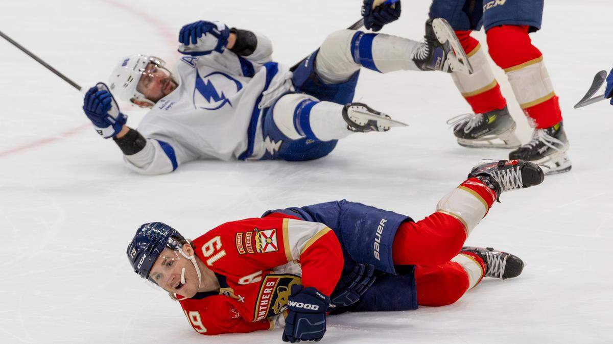 Florida Panthers left-wing Matthew Tkachuk (19) lies on the ice after being injured from a hit by Tampa Bay Lightning right-wing Nikita Kucherov (86) during the first period of an NHL game at Amerant Bank Arena on Monday, December 23, 2024, in Sunrise, Florida.