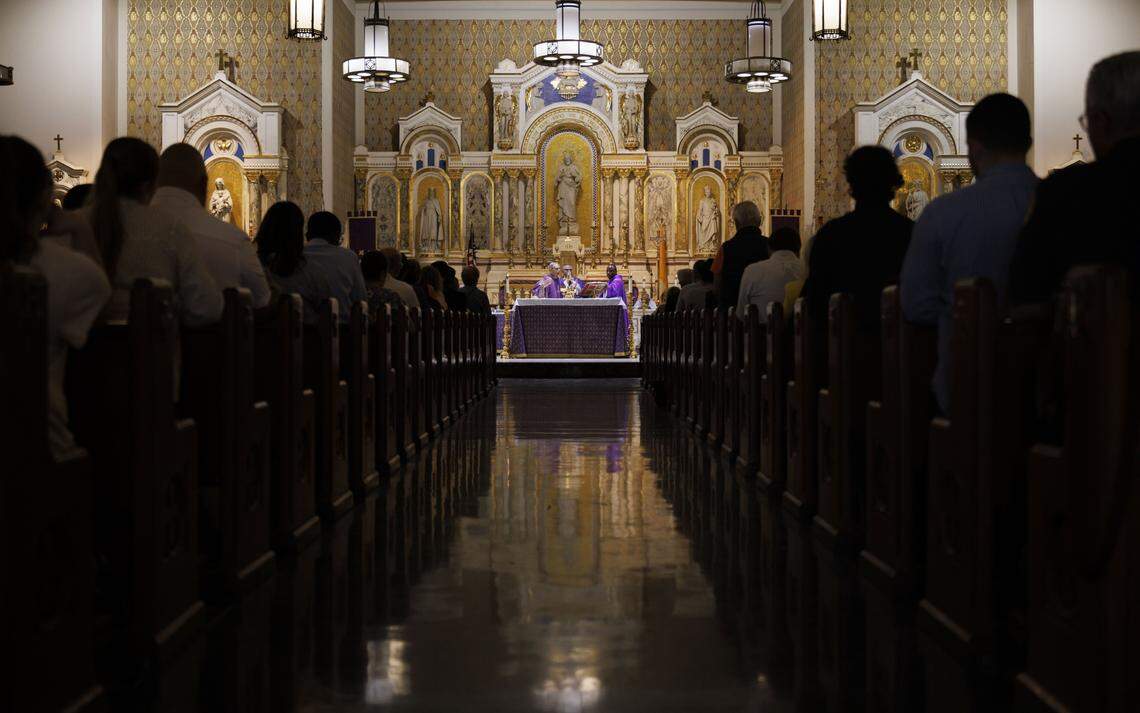 Fr. Orlando Portalatin, a Jesuit priest, leads Ash Wednesday mass on Wednesday, Feb. 18, 2026, at Gesu Catholic Church in downtown Miami.  The mass was fully packed with standing room only at the back of the church. 