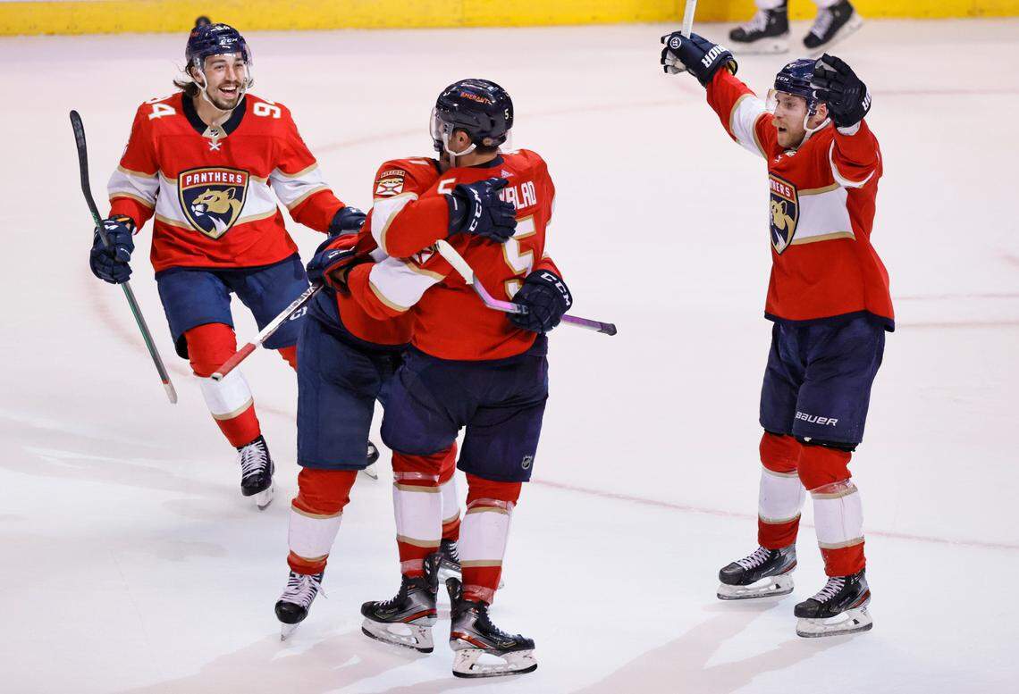Florida Panthers defenseman Aaron Ekblad (5) celebrate with Jonathan Huberdeau (11) Ryan Lomberg (94) and Sam Bennett (9) after scoring the winning goal against the Philadelphia during overtime of an NHL game at the FLA Live Arena on Wednesday, November 24, 2021 in Sunrise, Fl.
