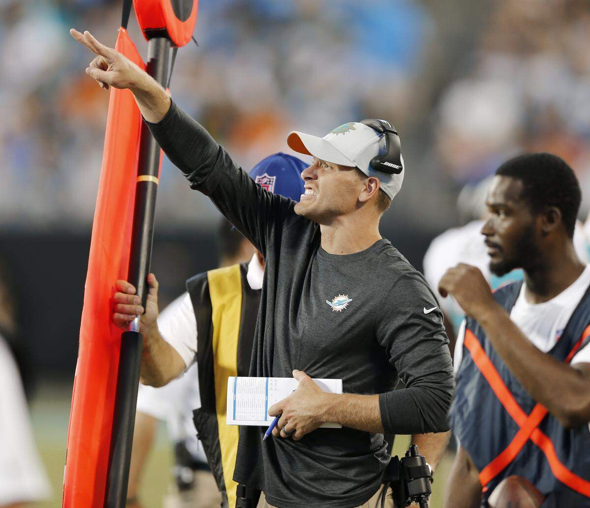 Miami Dolphins head coach Adam Gase directs his team against the Carolina Panthers in the first half of a preseason NFL football game in Charlotte, N.C., Friday, Aug. 17, 2018.