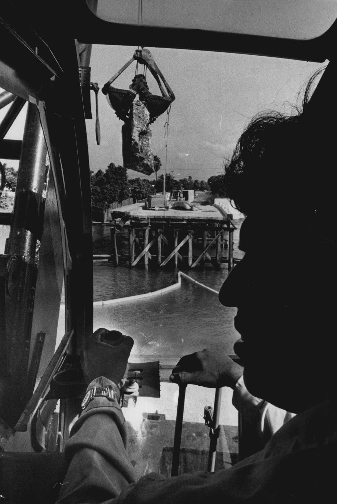 A crane operator lifts a concrete slab from the foundation of the Biarritz Drive Bridge in Normandy area of North Beach in 1982.