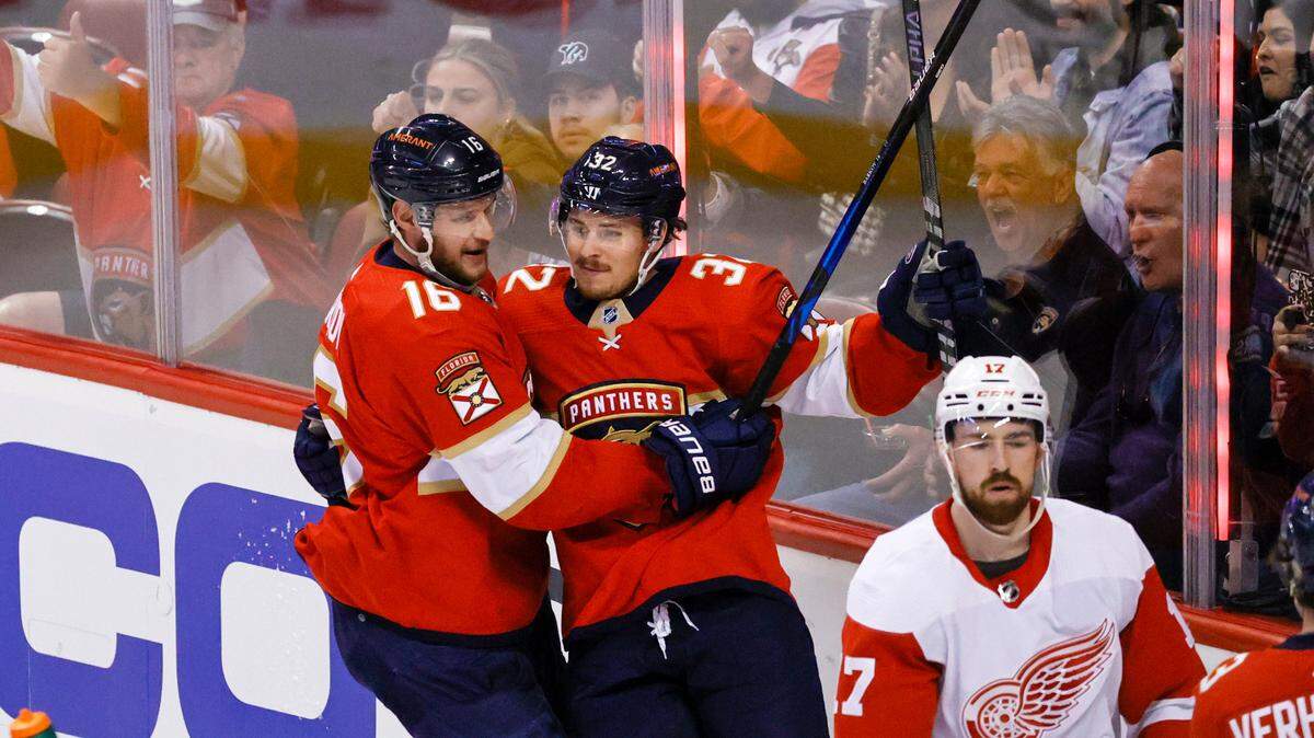 Florida Panthers defenseman Lucas Carlsson (32) celebrates with teammate Aleksander Barkov (16) after scoring a goal during the second period of an NHL game against the Detroit Red Wings at the FLA Live Arena on Saturday, March 5, 2022 in Sunrise, Fl.