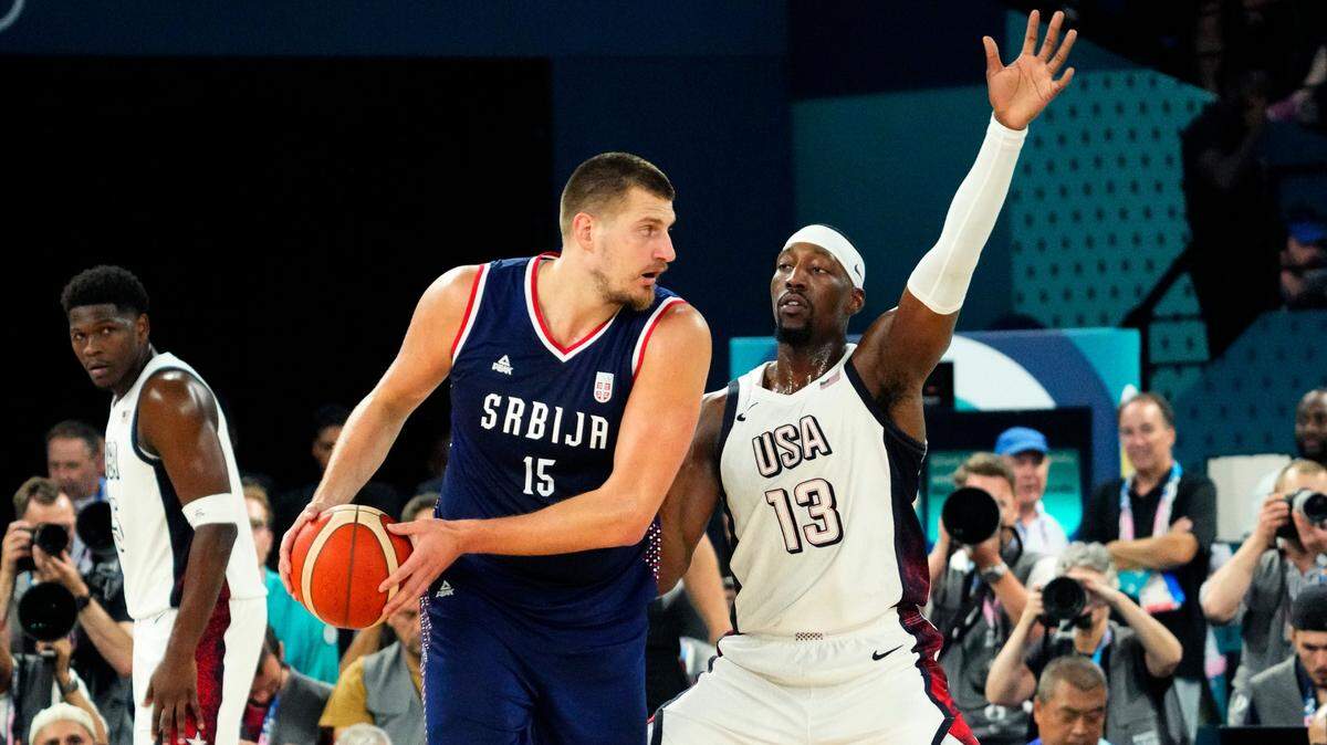 Serbia power forward Nikola Jokic (15) controls the ball while defended by United States centre Bam Adebayo (13) during the first half in a men’s basketball semifinal game during the Paris 2024 Olympic Summer Games at Accor Arena.