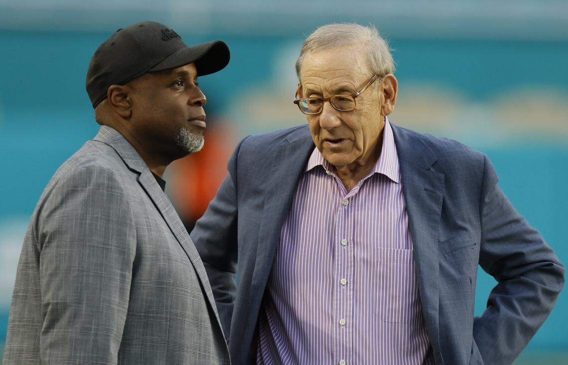 Miami Dolphins general manager Chris Grier and chairman of the board/managing general partner Stephen M. Ross on the field before the NFL game against the New York Jets at Hard Rock Stadium in Miami Gardens, Florida, on Monday, September 29, 2025.