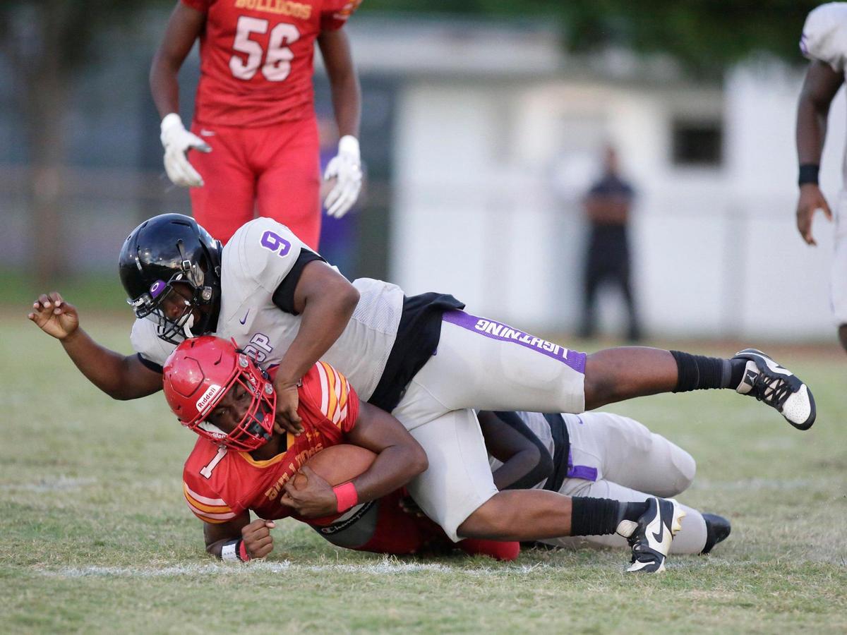 Dr. Krop Lightning linebacker Nathan Adras (9) tackles South Broward Bulldogs running back Chris Humphrey (1) during the football game on Friday, September 22, 2023 at South Broward HS in Hollywood. Andrew Uloza / for Miami Herald