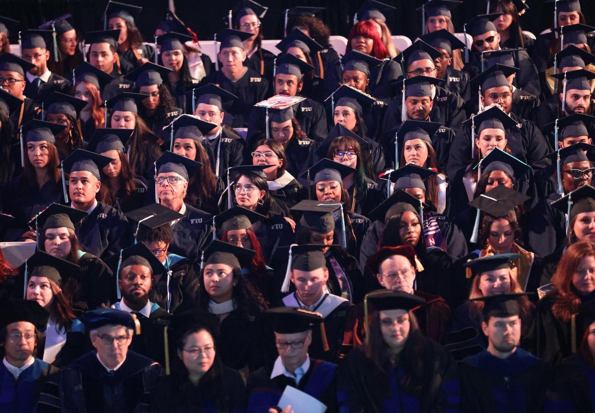 Students wait to be called on stage. 