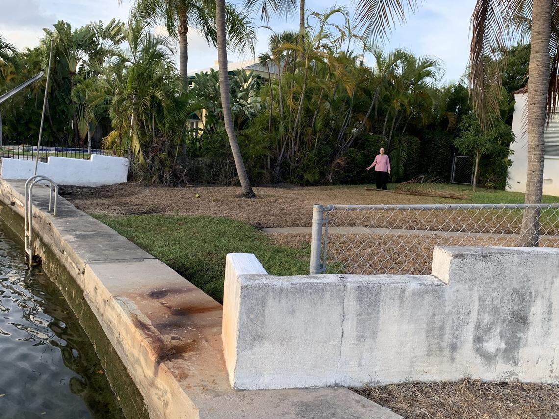 Daryle Prager, 81, stands at the highest point this year’s King Tides reached in her waterfront yard in Surfside. She said she doesn’t have much time before the water reaches her home, so she’s forced to sell the house.