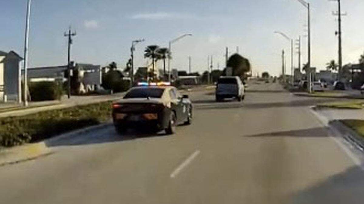 A Florida Highway Patrol cruiser chases an SUV north on U.S. 1 in the city of Marathon in the Florida Keys Sunday morning, Dec. 10, 2023.