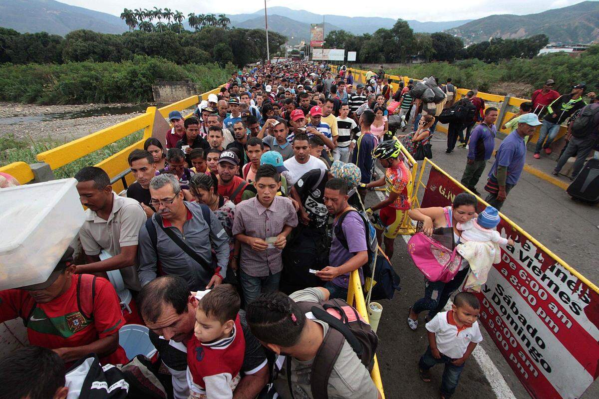 Venezuelan citizens cross the Simon Bolivar international bridge from San Antonio del Tachira in Venezuela to Norte de Santander province of Colombia on Feb. 10, 2018. Oil-rich and once one of the wealthiest countries in Latin America, Venezuela now faces economic collapse and widespread popular protest.