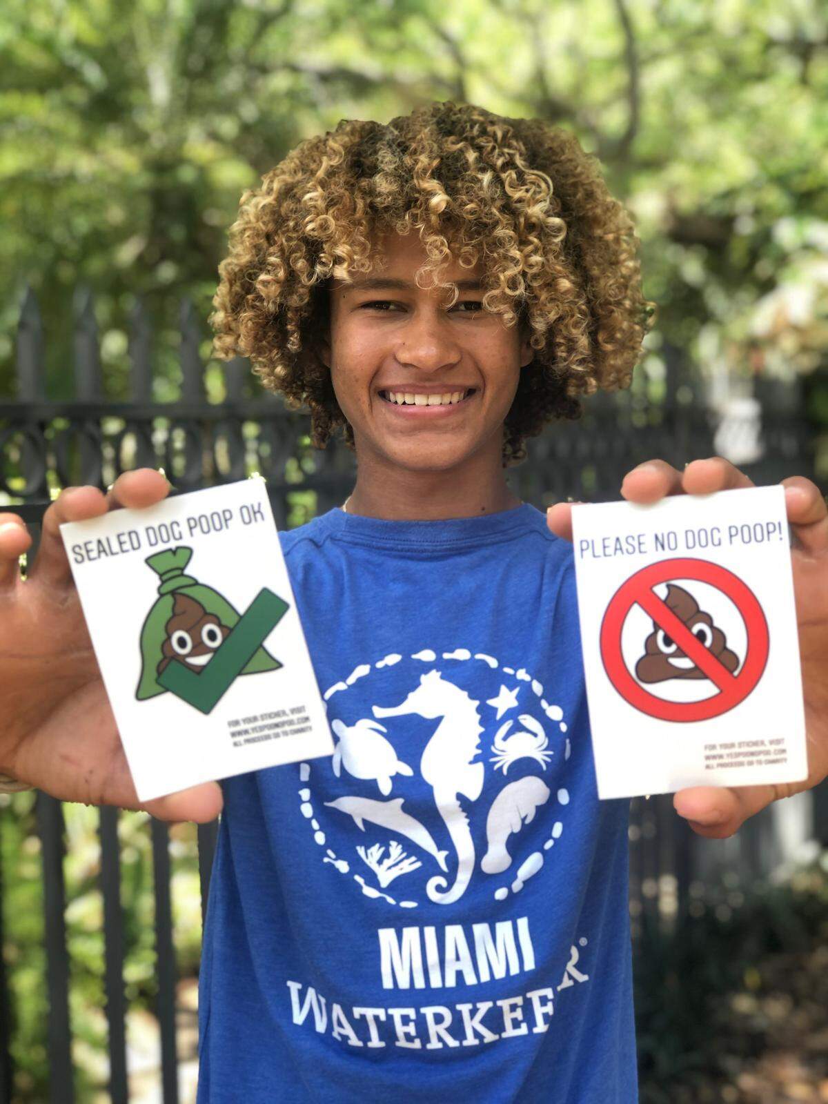 Jaïm Steel, a sophomore at MAST Academy, is raising funds for Feeding South Florida with his stickers that let dog walkers know whether they can drop their dog’s poop in a resident’s trash bin. 