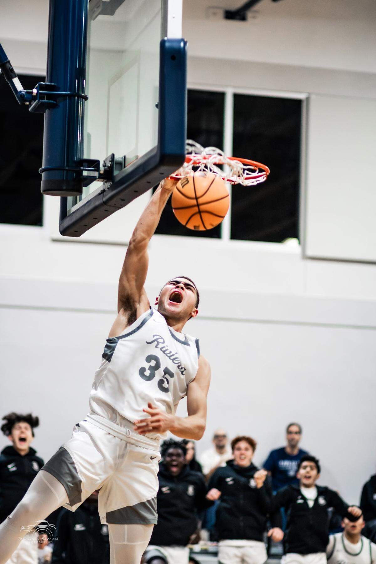 Riviera Prep’s Dante Allen slams home a bucket during the Bulldogs’ 63-49 win over Mater Lakes on Monday night at Riviera Prep.