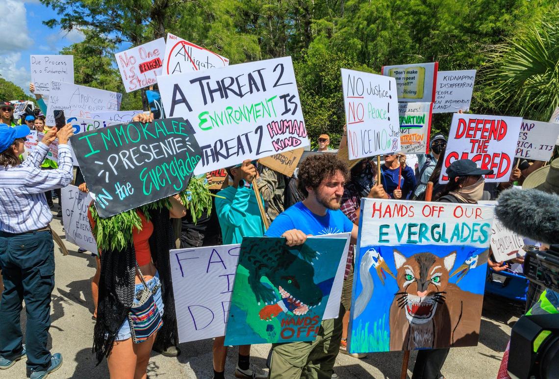 A group of people protested on US 41 Tamiami Trail against the visit of US President President Donald Trump and Florida Governor Ron DeSantis, while they toured the migrant detention center, dubbed “Alligator Alcatraz,” located at the site of the Dade-Collier Training and Transition Airport in Ochopee, Florida on July 1, 2025.