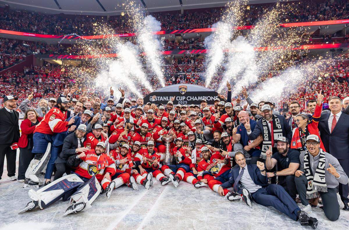 Florida Panthers players and staff gather for a team photo around the Stanley Cup after they defeated the Edmonton Oilers in Game 6 of the Final series at Amerant Bank Arena on Tuesday, June 17, 2025, in Sunrise, Fla.