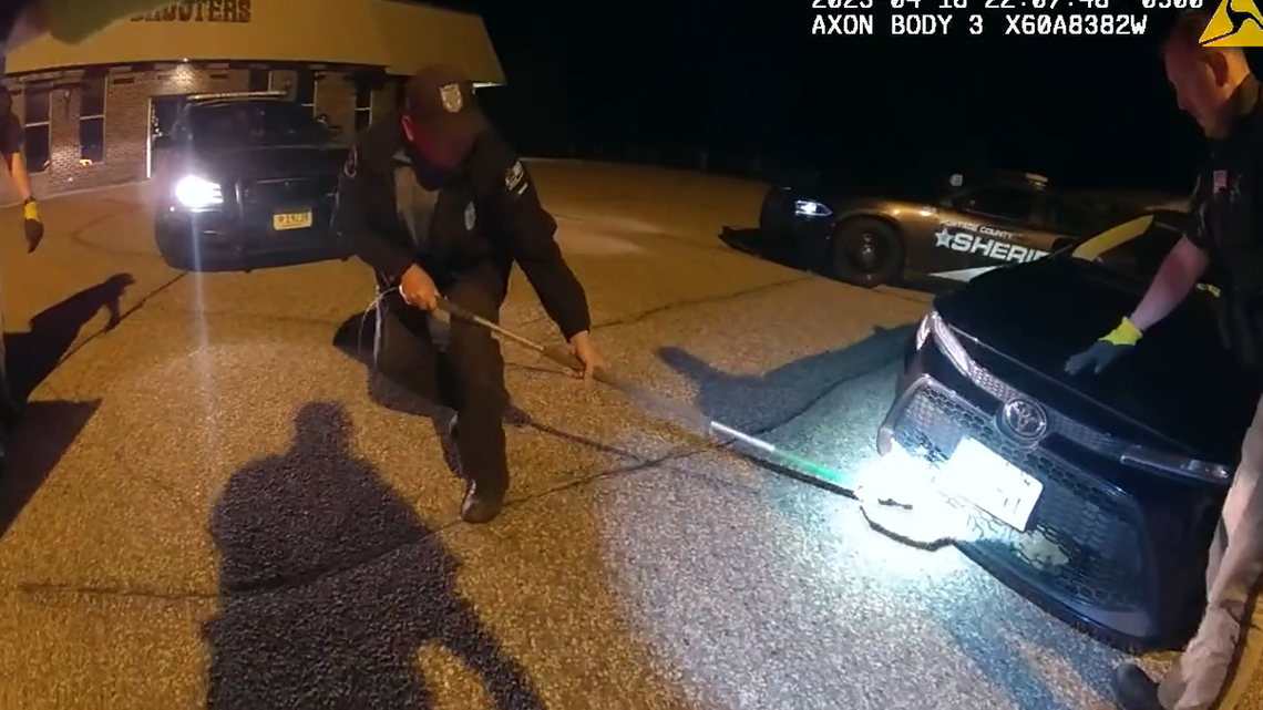 An elusive animal trapped behind the grille of a car was rescued by deputies and conservation officers in Wisconsin, video shows.