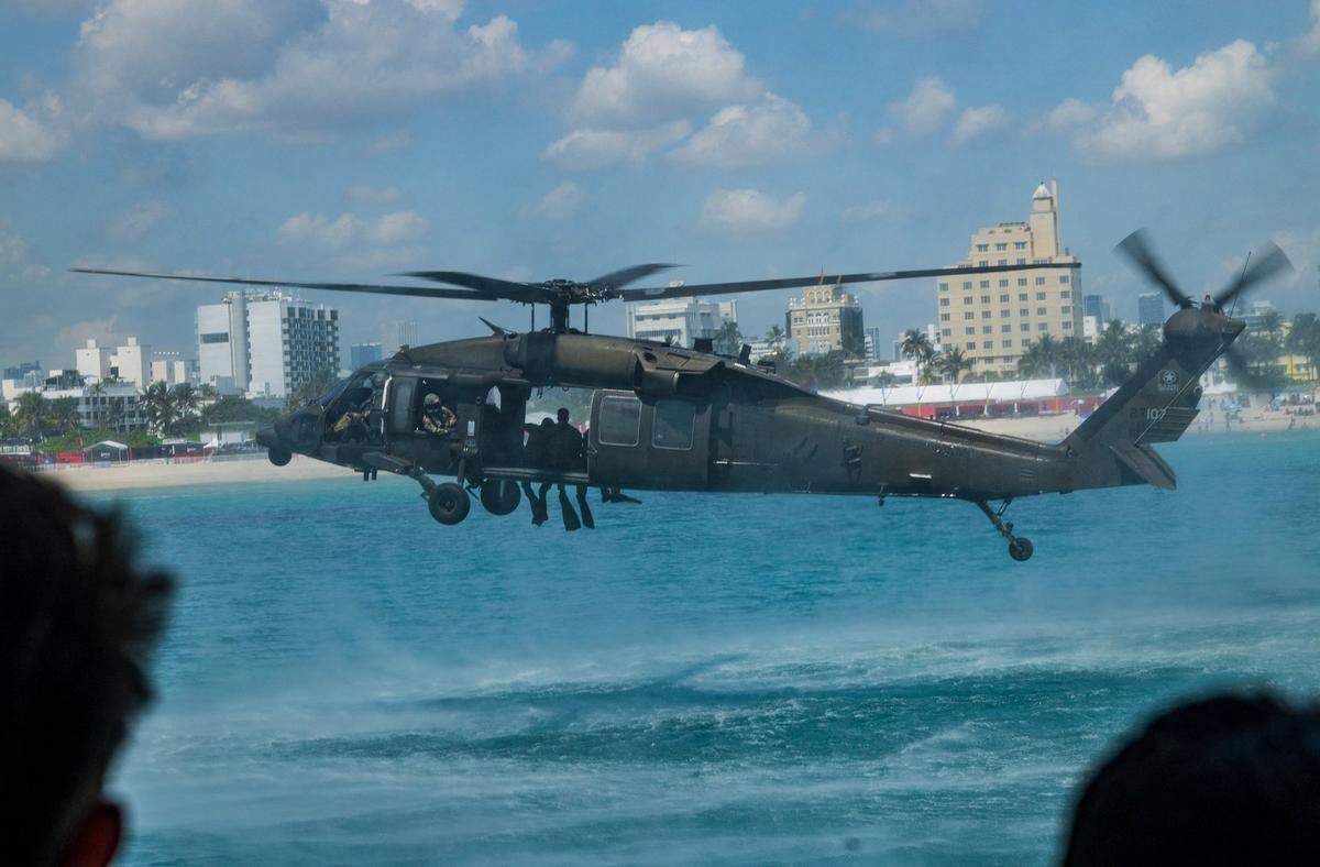 Divers from the 8-229th Assault Helicopter Battalion (AHB), based at Fort Knox, Ky., prepare to plunge into the ocean during a training exercise over South Beach ahead of the Hyundai Air & Sea Show, part of Miami Beach’s annual National Salute to America’s Heroes, on Friday, May 23, 2025.