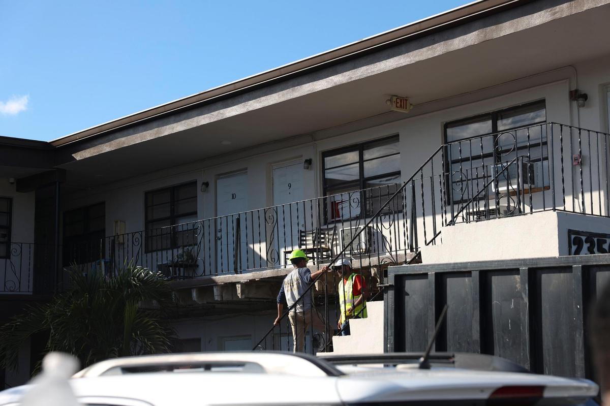 Crews assess damage on the staircase of the walkway that collapsed at a building on Palm Avenue in Hialeah on Monday morning, Oct. 31, 2022.
