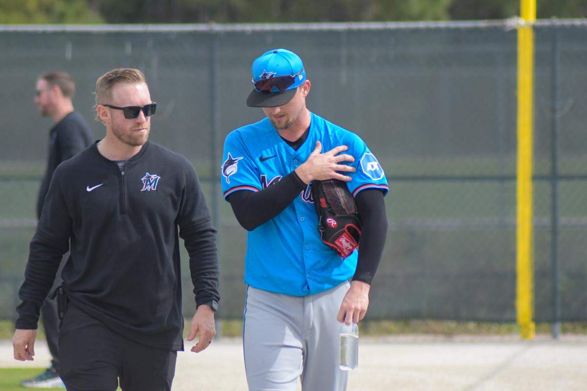 Miami Marlins left-handed pitcher Braxton Garrett walks off a back field at the Roger Dean Chevrolet Stadium complex with a training after a spring training workout in Jupiter, Florida, on Friday, Feb. 16, 2024.