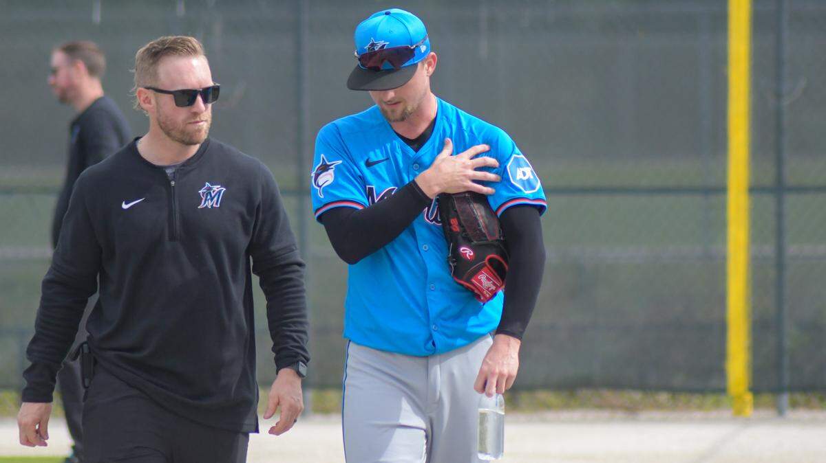 Miami Marlins left-handed pitcher Braxton Garrett walks off a back field at the Roger Dean Chevrolet Stadium complex with a training after a spring training workout in Jupiter, Florida, on Friday, Feb. 16, 2024.