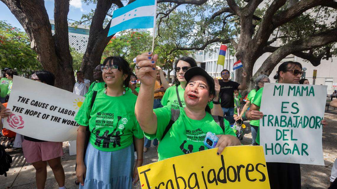 Ericka Varela (center) from Honduras holds the Honduras flag during an event to commemorate International Domestic Workers’ Day. Domestic workers gathered at Miami-Dade Government Center to demand fair wages, protections, and respect. The event was organized by WeCount! and The Women’s Fund Miami-Dade, June 16, 2025.