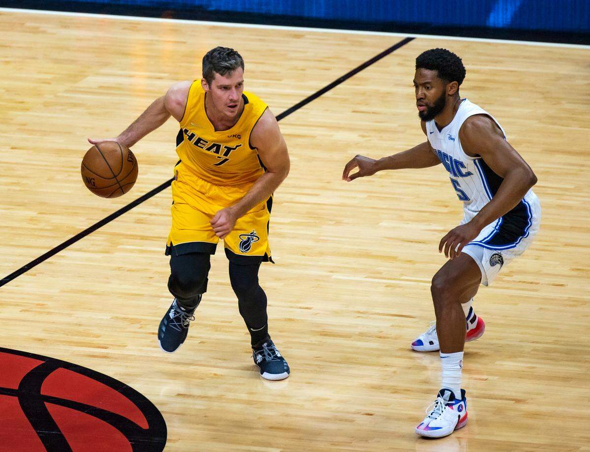 Miami Heat guard Goran Dragic (7) drive against Orlando Magic guard Chasson Randle (25) in the first quarter of their NBA basketball game at AmericanAirlines Arena on Thursday, March 11, 2021.